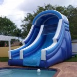 big blue water slide with no pool