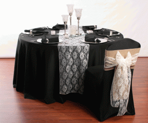 table with black linen and chair cover with sashes
