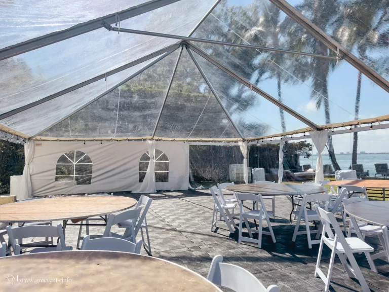 portable floor system under a clear tent setup with round tables and white chairs
