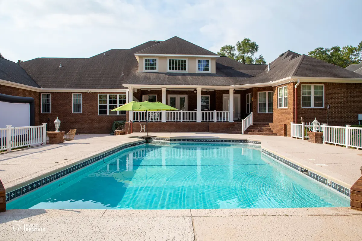 Uncovered residential pool before installing a plexiglass pool cover for a backyard wedding or private event
