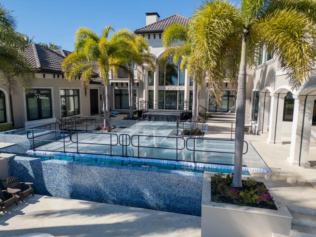 Acrylic pool cover dance floor installed over infinity edge pool in Naples Florida for corporate event